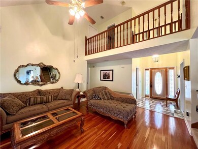Living room featuring hardwood and high vaulted ce