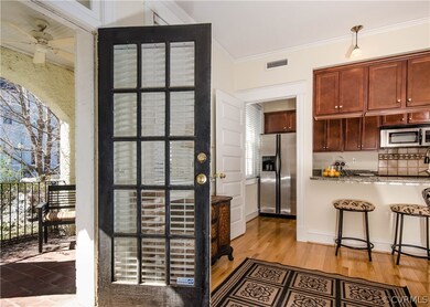 The foyer has hardwood floors, and is open to the living room and kitchen.