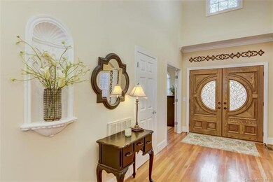 Two story foyer with double door entry.