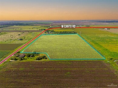Aerial view of sparsely populated area featuring property parcel outlined and rows of crops