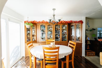 Dining space with a chandelier and wood finished floors