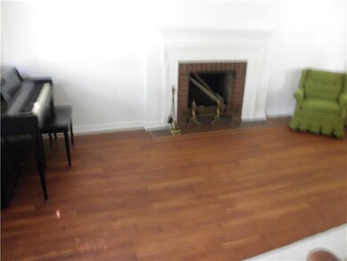 Living Room. EXPOSED HARDWOOD FLOOR AND LOG BURNIN