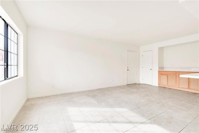 Spare room with light tile patterned flooring