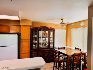 Dining space featuring a ceiling fan and light til