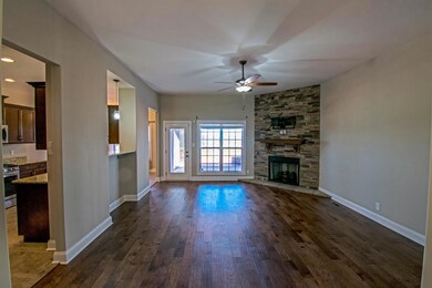 Great Room with Hardwood Flooring, Corner Stone Fireplace , Ceiling Fan, 10 ft Ceiling, and Bluff View!