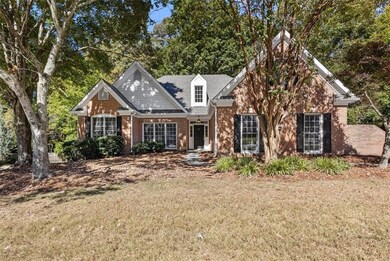 View of front of house with brick siding and a front lawn
