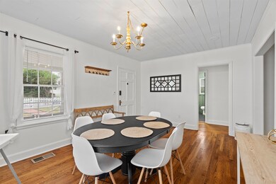 Dining space with a chandelier, dark wood-style flooring, and wooden ceiling