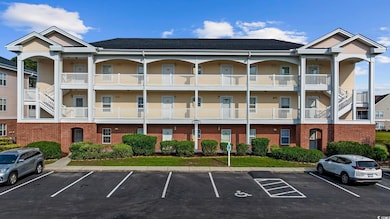 View of building exterior with uncovered parking and stairs