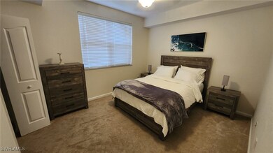 Bedroom featuring carpet flooring and baseboards