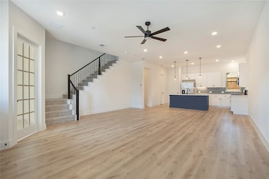 Unfurnished living room featuring stairs, recessed lighting, light wood-style flooring, and ceiling fan