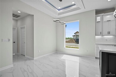 Unfurnished dining area featuring marble finish floor, baseboards, visible vents, and recessed lighting