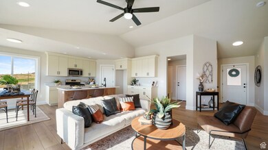 Living room featuring light wood finished floors, a ceiling fan, vaulted ceiling, and recessed lighting