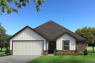 View of front of house with board and batten siding, a front yard, an attached garage, brick siding, and driveway