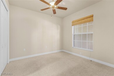 Empty room featuring carpet, baseboards, and a cei