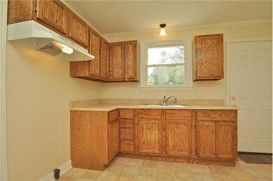 Kitchen with brand new cabinets, counters, and floor.