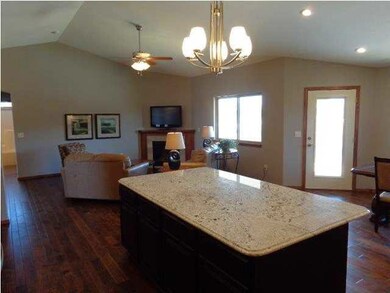 White granite with chocolate cabinet island.