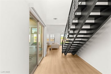 Stairs featuring wood finished floors and baseboar