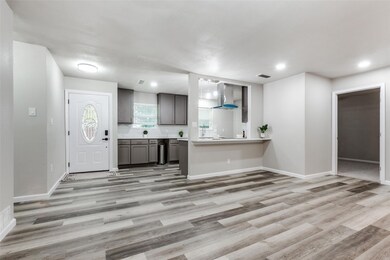 Kitchen featuring kitchen peninsula, light hardwoo