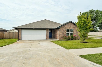 View of front of house with brick siding, an attached garage, driveway, and roof with shingles
