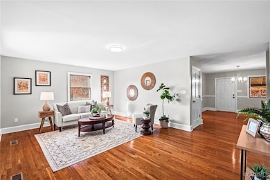 Living room with dark hardwood / wood-style floori