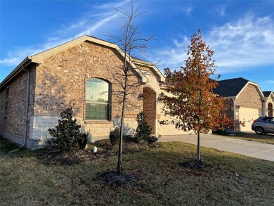 View of front of property featuring brick siding, a garage, and concrete driveway