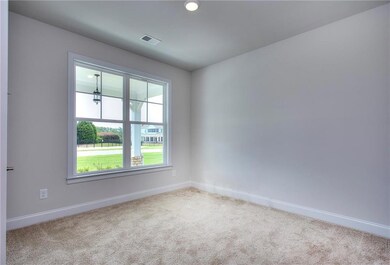 Carpeted empty room featuring baseboards and reces