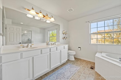 Relax in the updated primary bath featuring a walk