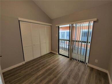 Unfurnished bedroom featuring dark wood-style flo