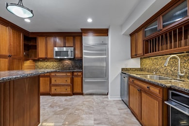 Kitchen with decorative backsplash, appliances wit