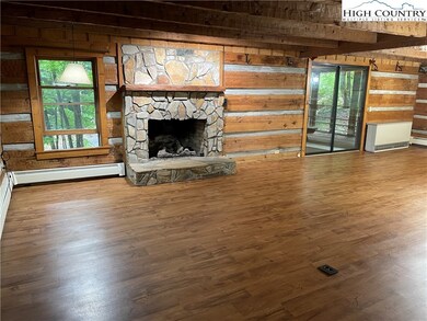 Large living room with stone fireplace.