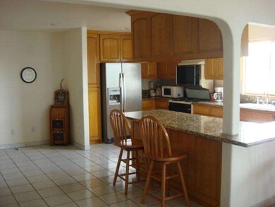 Kitchen breakfast bar on same side as dining room.
