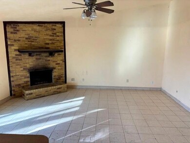Living room with tile floor and woodburning firepl
