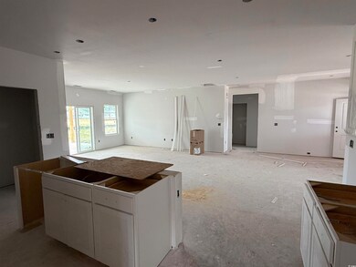 Kitchen with open floor plan, white cabinets, and 