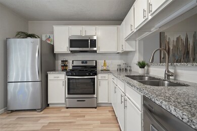 The kitchen has plenty of countertop space for easy meal prep and an automatic dishwasher and deep basin sinks with upgraded fixtures for effortless clean up.