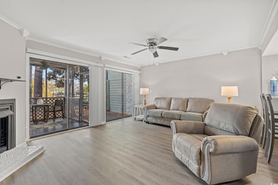 Living room with ceiling fan, light wood-type floo