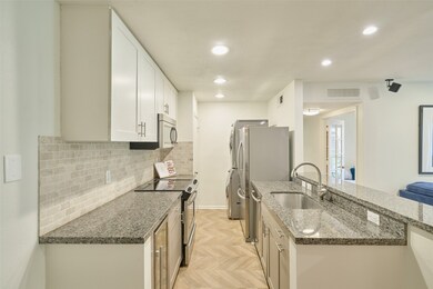 The herringbone pattern flooring extends to the ki
