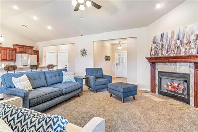 Living room featuring ceiling fan, light colored c