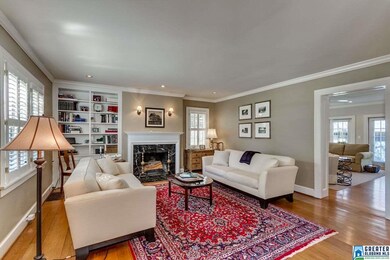 Built in bookcase and fireplace with marble surrou