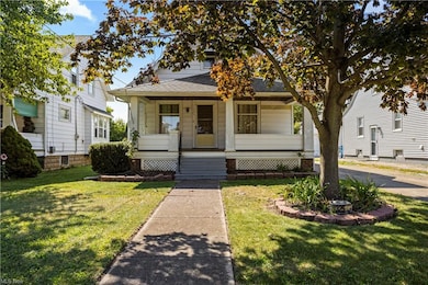 Bungalow-style home with a porch and a front lawn