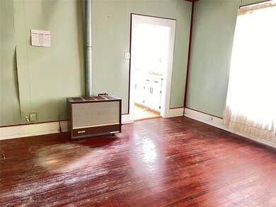 Spare room with dark wood-type flooring