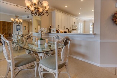 Carpeted dining space with an inviting chandelier 