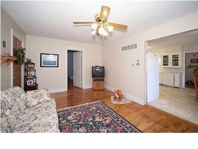 The living room is open to the kitchen & dining