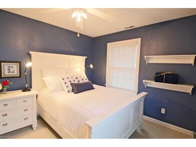 A calming second bedroom is crisp and bright.