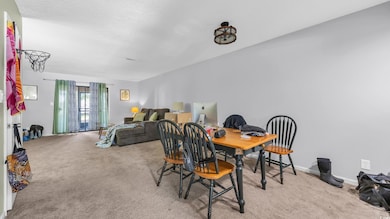 Dining room with carpet floors and baseboards