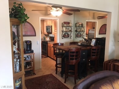 Bar with light tile patterned floors, ceiling fan,