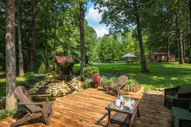 Excellent Area for Entertaining! Back porch pond w/water mill, short distance to Large Inground Pool.