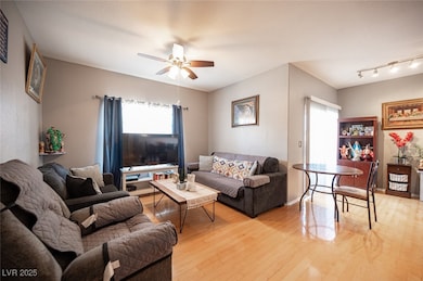 Living area featuring ceiling fan, light wood-type