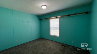 Carpeted empty room with a textured ceiling