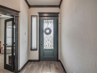 Carpeted entryway featuring a wealth of natural li