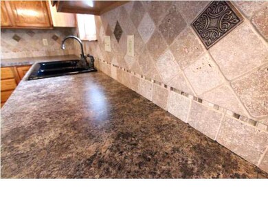 Nice view of the new tile, counter tops,sink and f